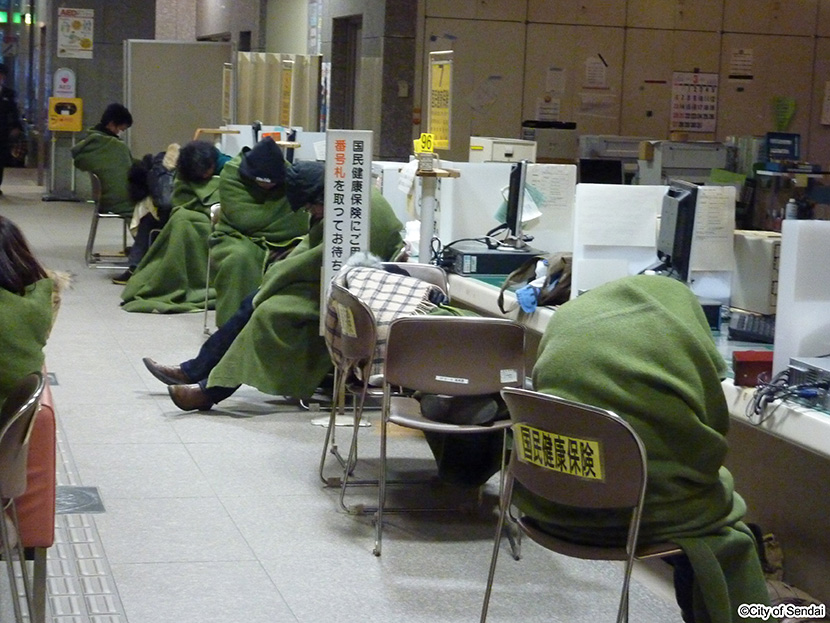 画像：太白区役所庁舎内に避難し、毛布で暖をとる人々