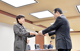 斎藤市議会議長より中間報告書を手渡される市長